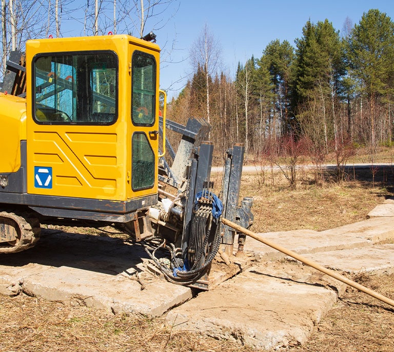 a truck is parked on the side of a dirt field