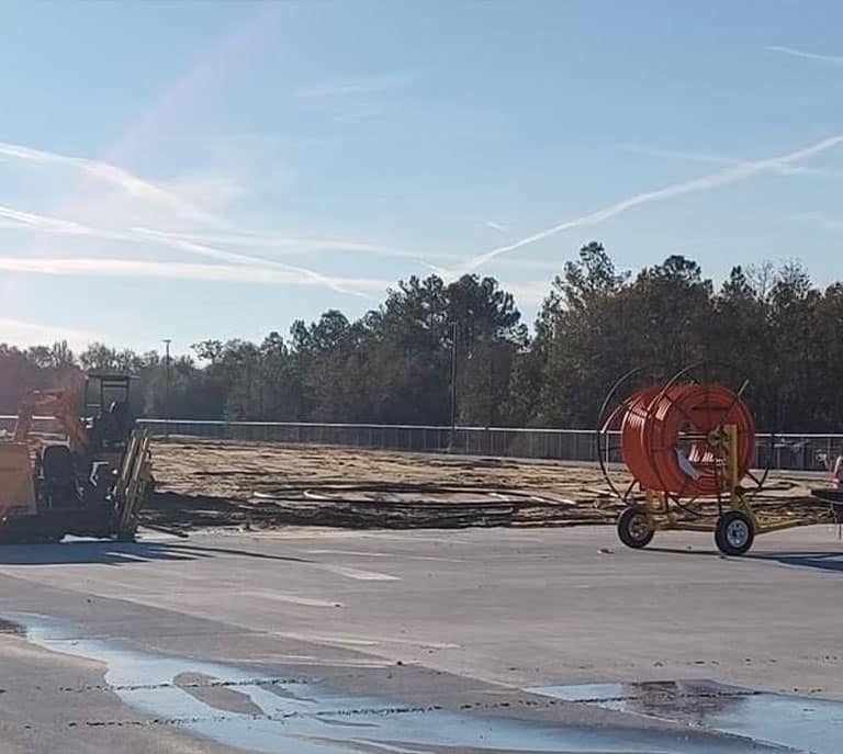 a horse drawn carriage parked on the side of a road
